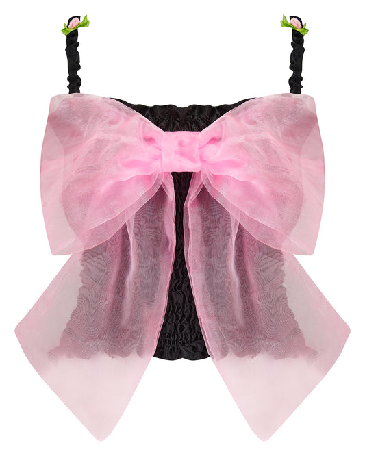 A black satin top with an elasticated shirring bodice and a large bubblegum pink organza bow on the front. It features elasticated shoulder straps with ruched detailing and is displayed against a plain background. Delta Of Phoenix Georgette Bow Top