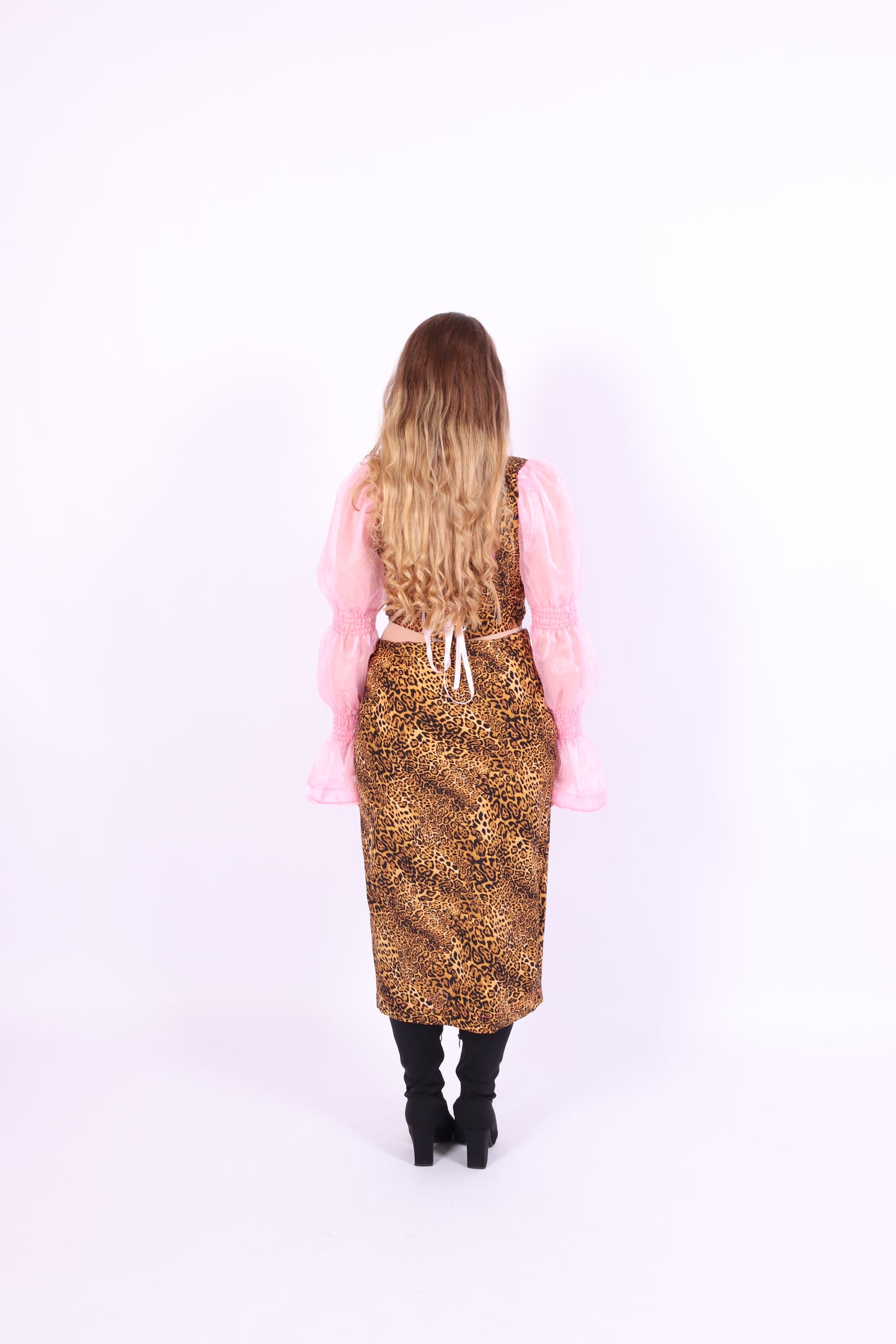 A leopard print midi skirt with pink rosette detailing at the waist, fastened with an invisible side zip. Delta Of phoenix Francine Midi Skirt