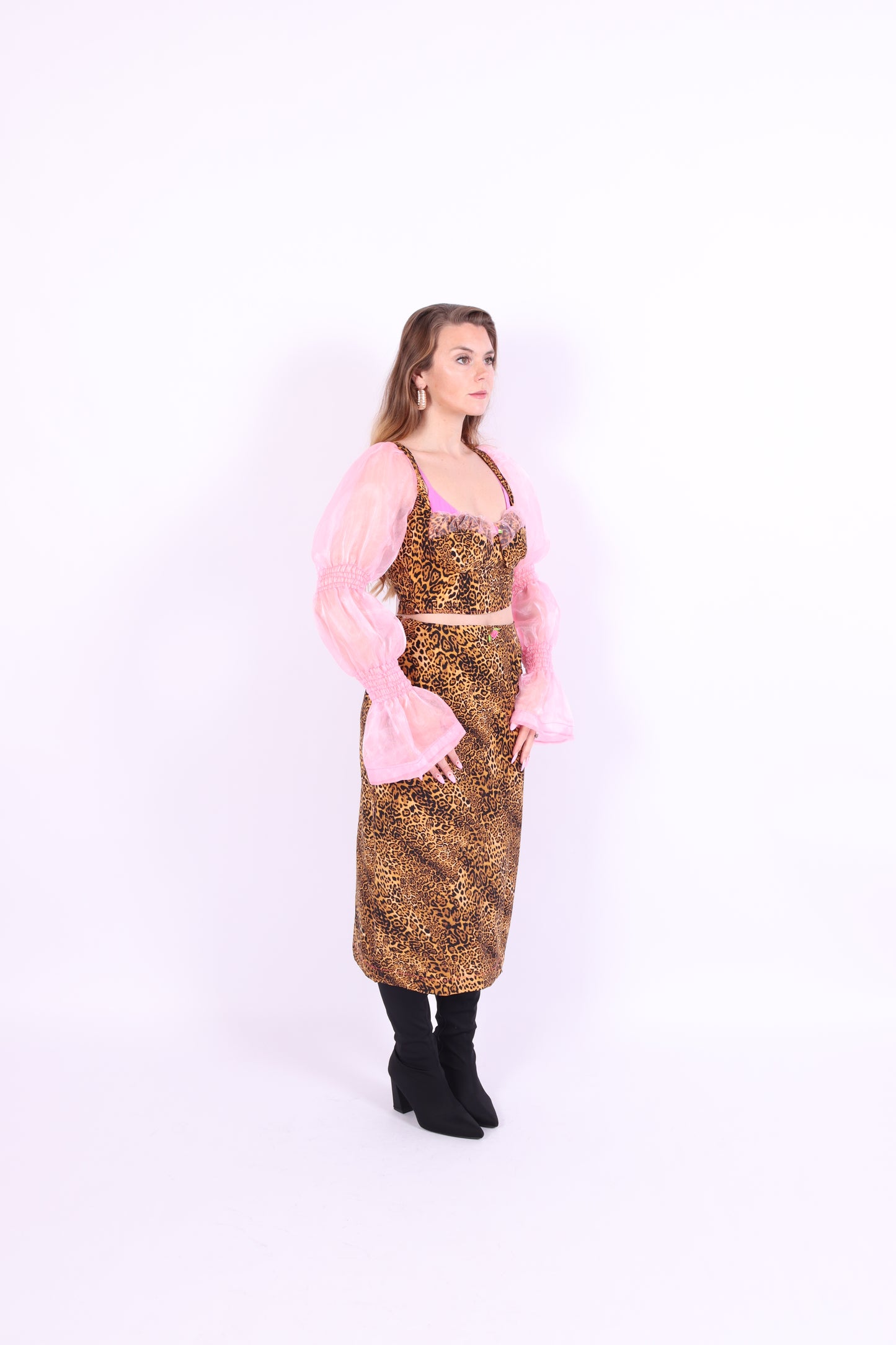 A luxury leopard print corset top with bubblegum pink organza sleeves and rosette detailing, primarily designed as a crop top. Delta Of phoenix Francine Corset Top