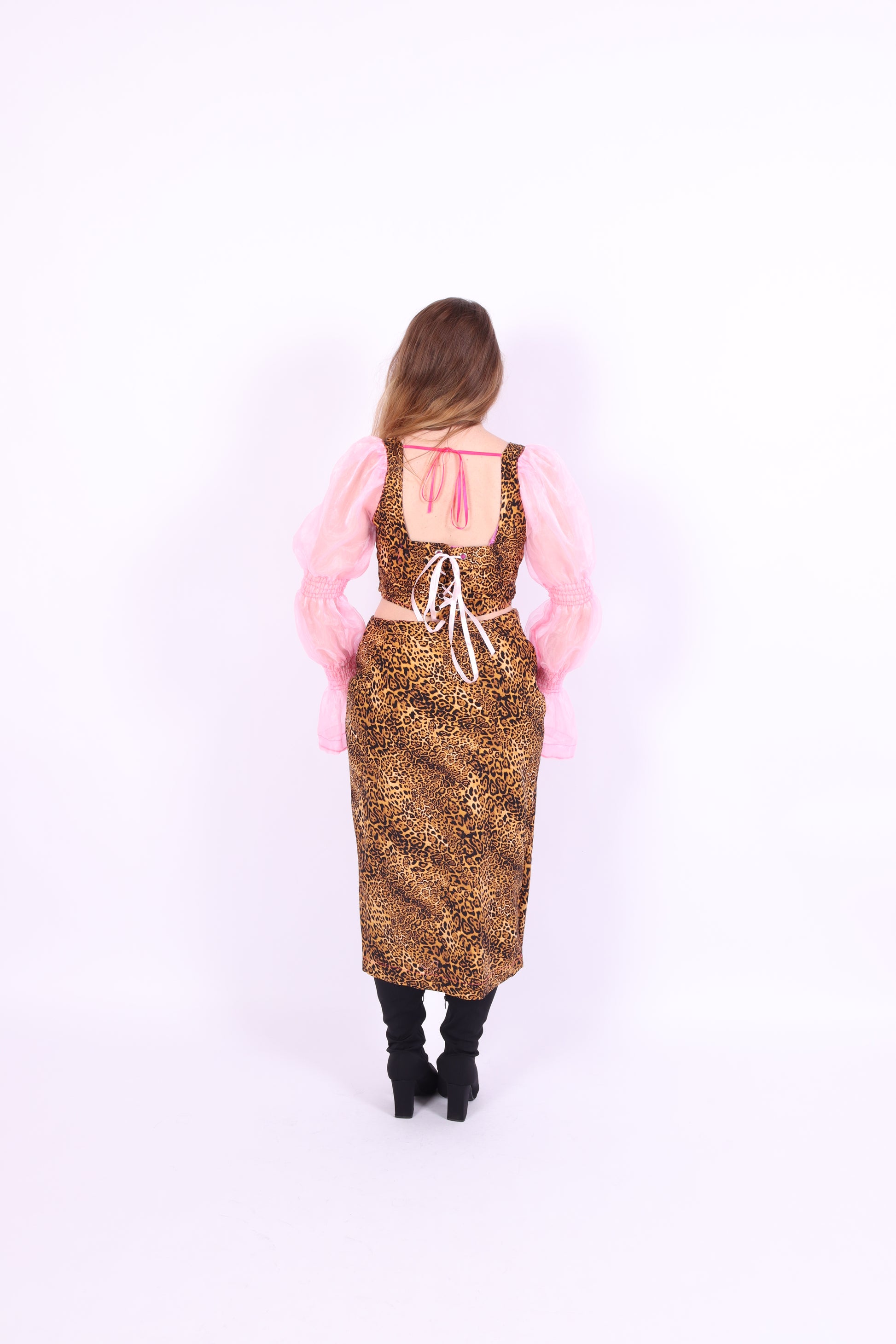 A luxury leopard print corset top with bubblegum pink organza sleeves and rosette detailing, primarily designed as a crop top. Delta Of phoenix Francine Corset Top