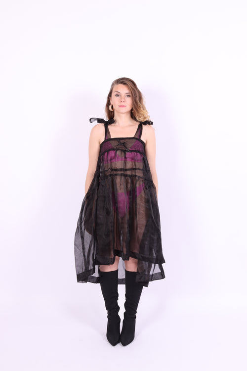 Black organza waterfall dress with a flowing full skirt, organza bow shoulder straps, and an elasticated shirring panel across the top bodice. Delta of phoenix buffy 2.0 dress
