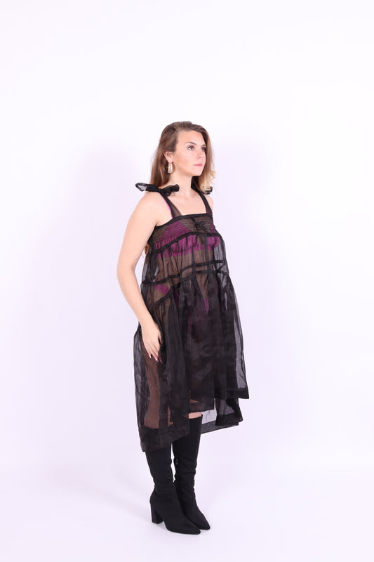 Black organza waterfall dress with a flowing full skirt, organza bow shoulder straps, and an elasticated shirring panel across the top bodice. Delta of phoenix buffy 2.0 dress