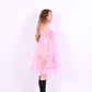A bubblegum pink organza mini dress with a large bow detail at the sleeve, skirt, and front, featuring a bardot neckline and long puff sleeves. Cosette Dress by Delta Of Phoenix