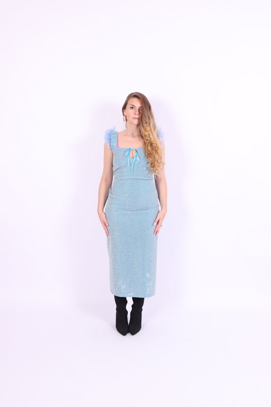 A blue glitter cocktail dress with ruffle detailing, elasticated ruched straps, and a ribbon bow keyhole detail at the front. Delta Of Phoenix Juni Midi Dress