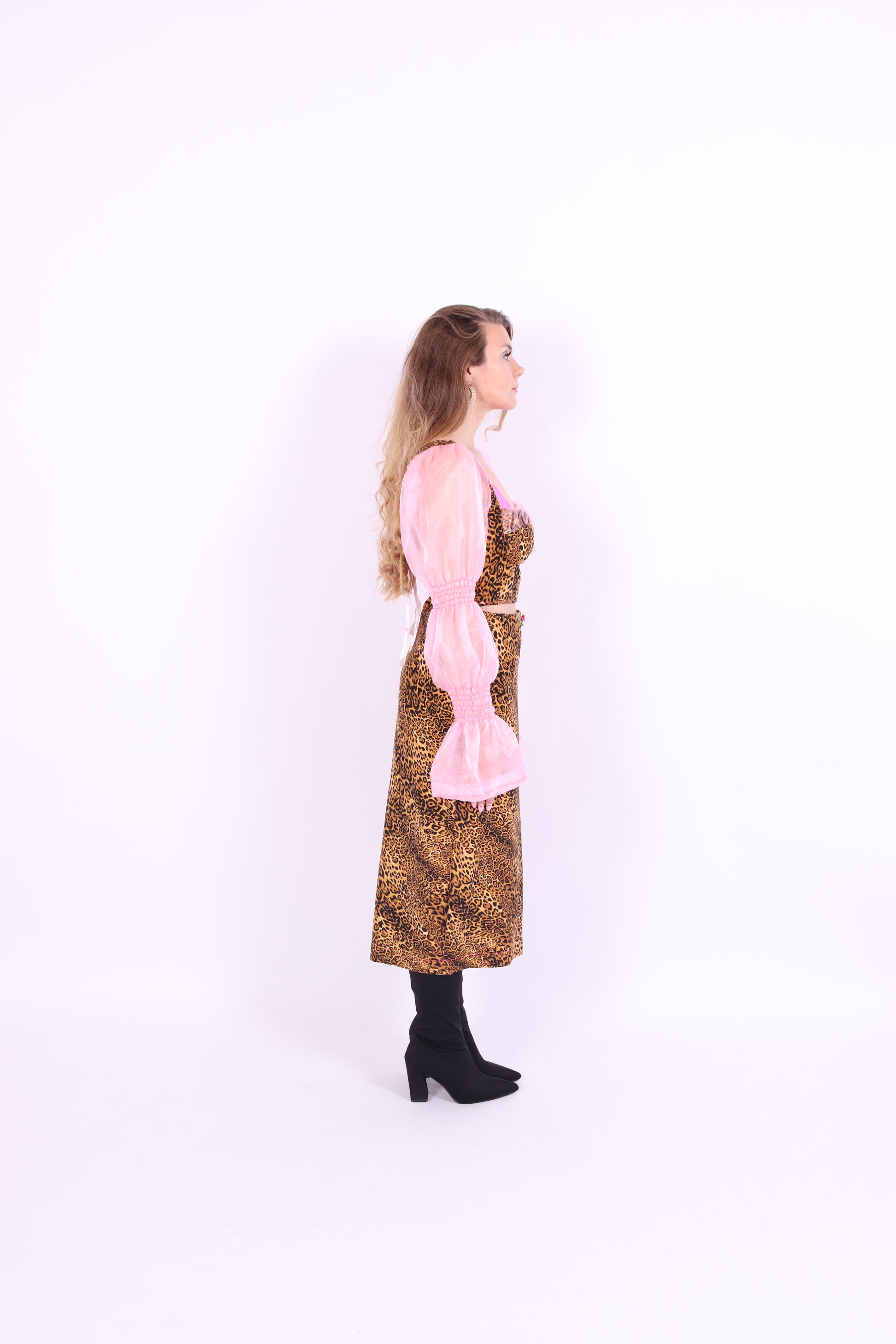 A leopard print midi skirt with pink rosette detailing at the waist, fastened with an invisible side zip. Delta Of phoenix Francine Midi Skirt