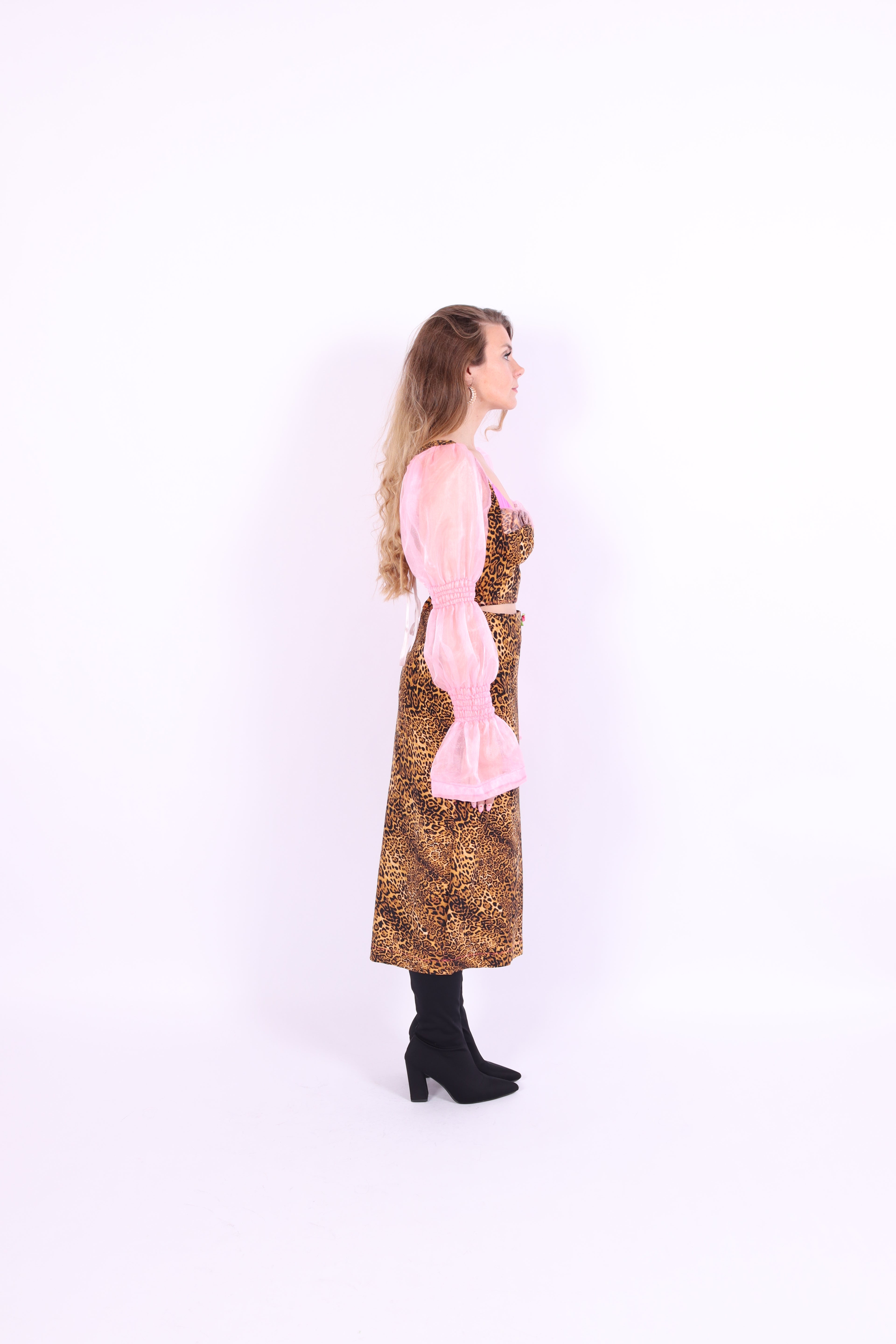 A leopard print midi skirt with pink rosette detailing at the waist, fastened with an invisible side zip. Delta Of phoenix Francine Midi Skirt