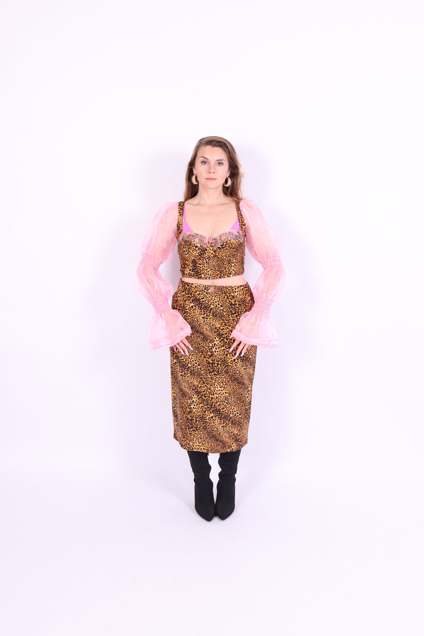 A leopard print midi skirt with pink rosette detailing at the waist, fastened with an invisible side zip. Delta Of phoenix Francine Midi Skirt