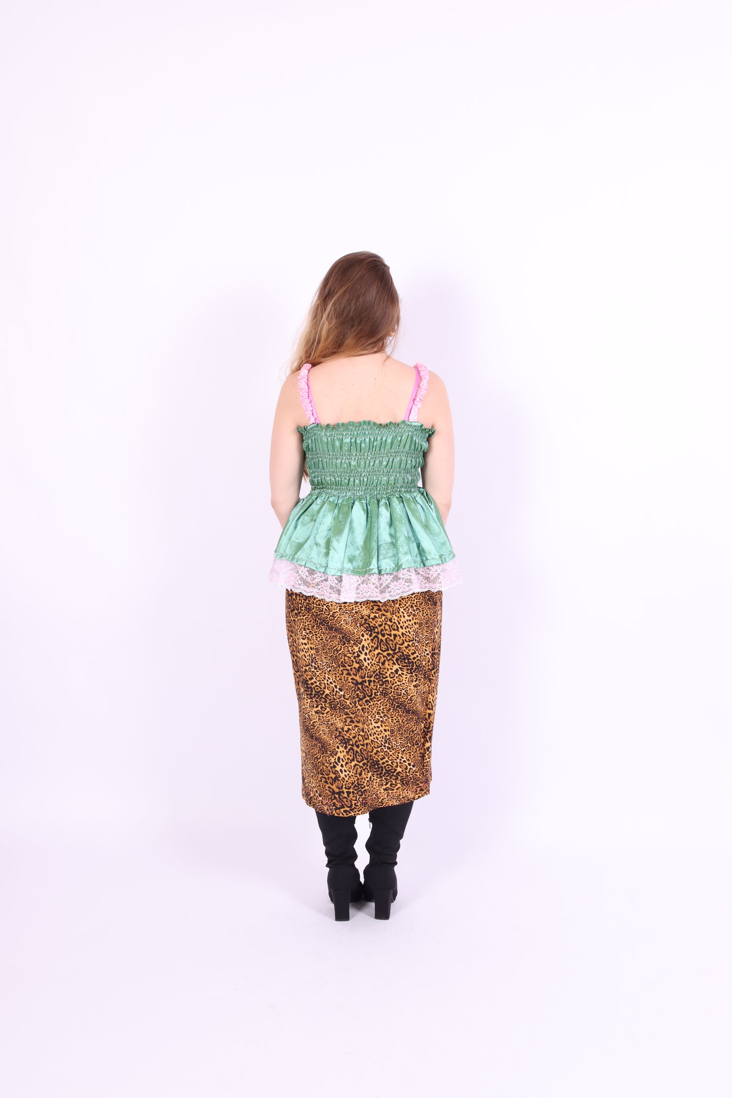 A pistachio green taffeta top with pink scalloped lace detail and a bow on the front, featuring pink topstitch elasticated shirring bodice and baby pink taffeta shoulder straps with rosette detail. Delta Of Phoenix Göta Bow Top