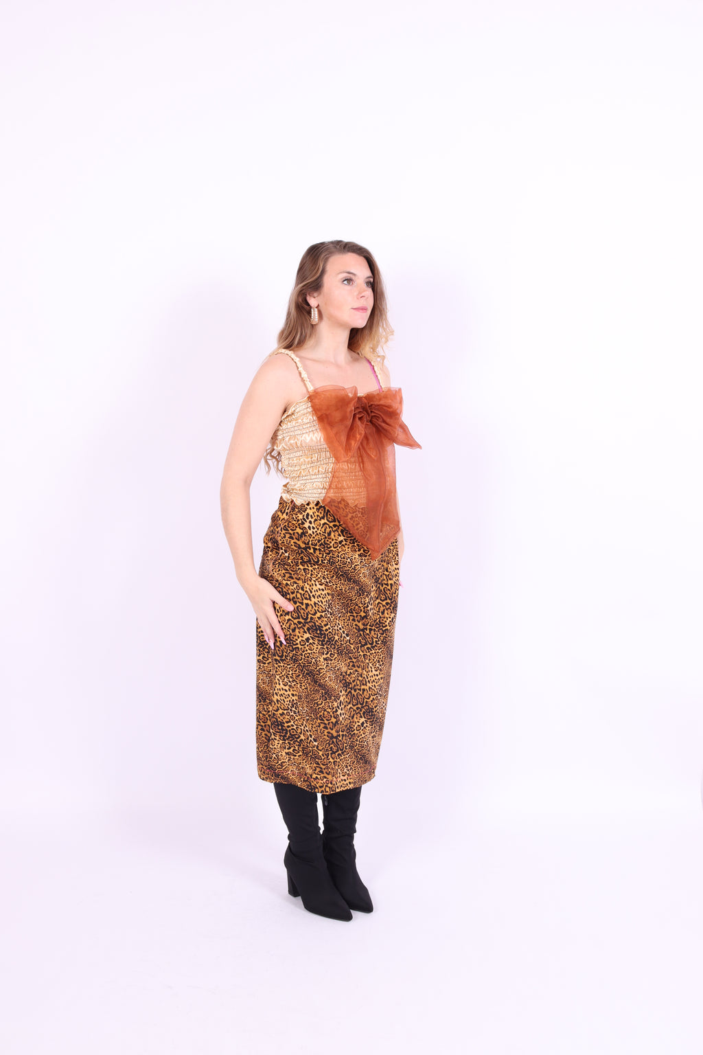A gold satin top with an elasticated shirring bodice and a terracotta brown organza bow on the front. It features shoulder straps with elasticated and ruched details. Delta Of Phoenix Naomi Bow Top