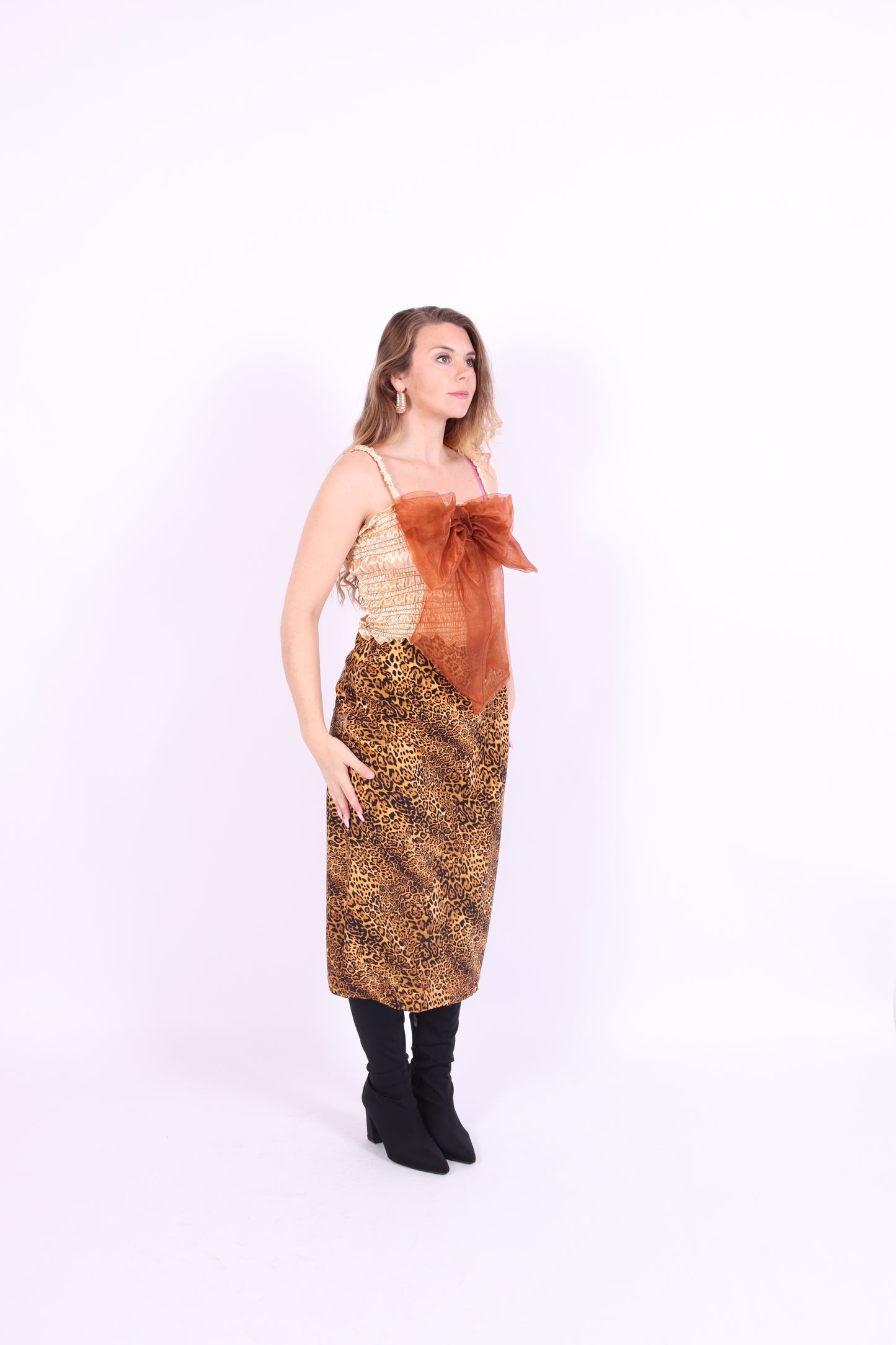 A gold satin top with an elasticated shirring bodice and a terracotta brown organza bow on the front. It features shoulder straps with elasticated and ruched details. Delta Of Phoenix Naomi Bow Top