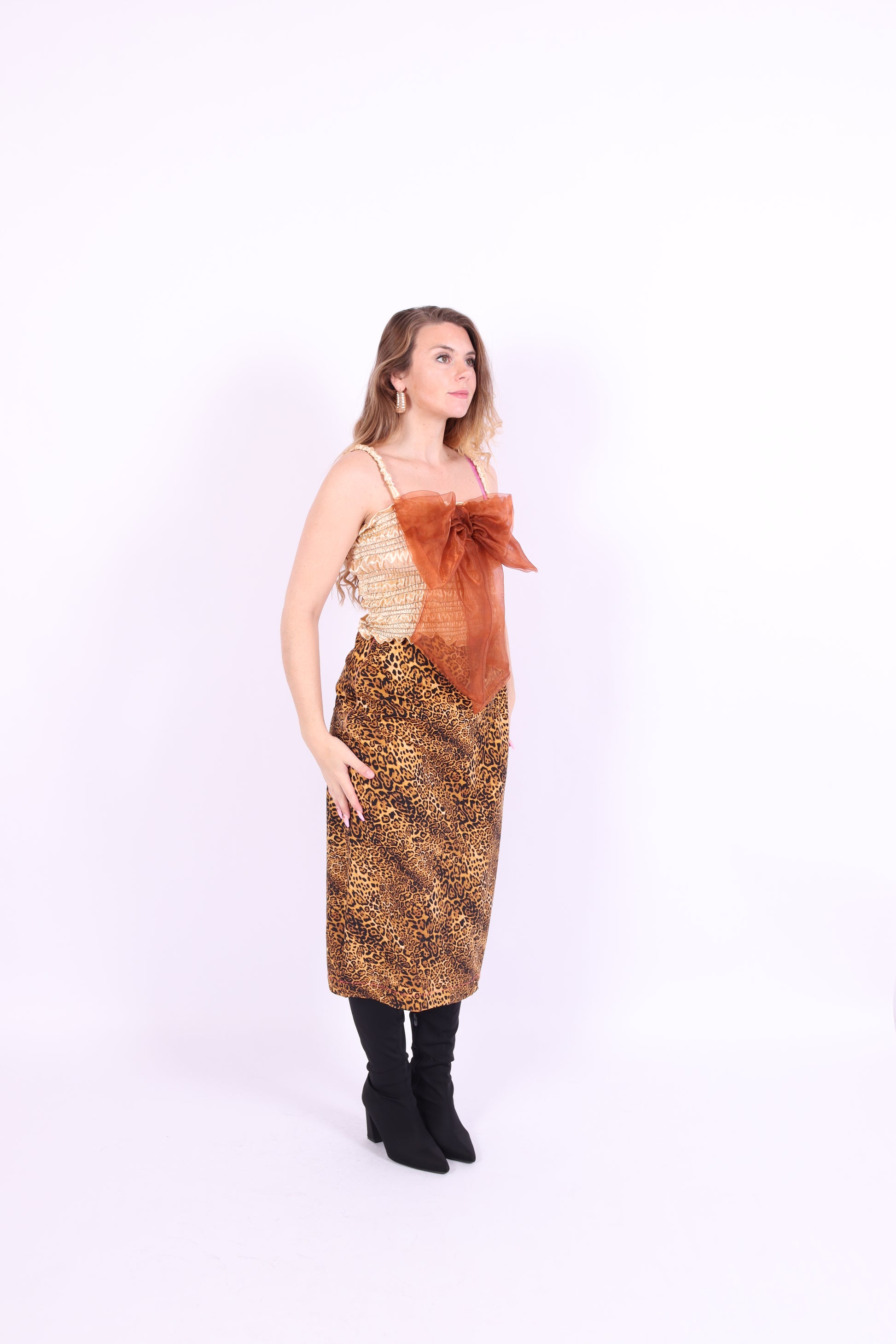 A gold satin top with an elasticated shirring bodice and a terracotta brown organza bow on the front. It features shoulder straps with elasticated and ruched details. Delta Of Phoenix Naomi Bow Top