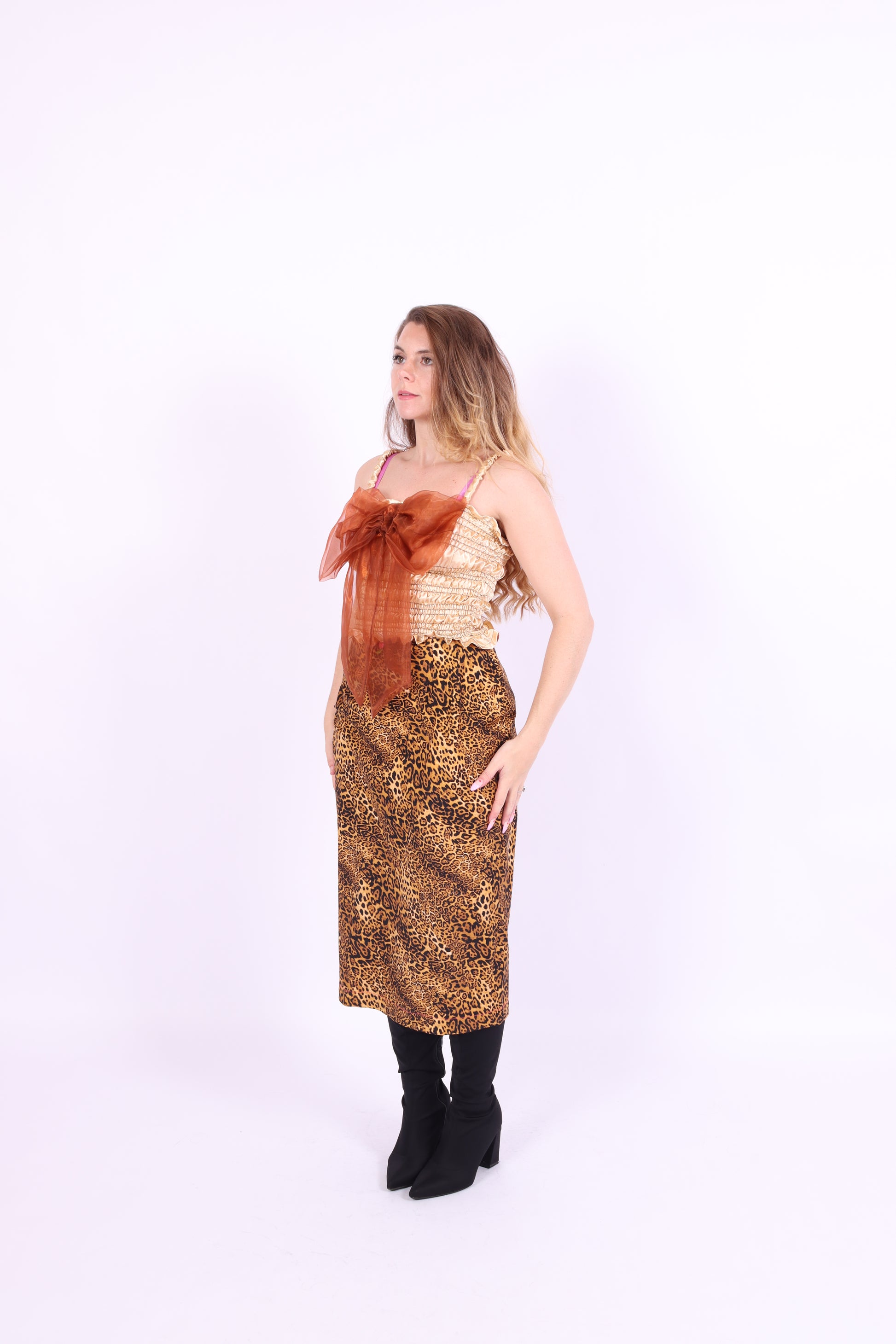 A gold satin top with an elasticated shirring bodice and a terracotta brown organza bow on the front. It features shoulder straps with elasticated and ruched details. Delta Of Phoenix Naomi Bow Top