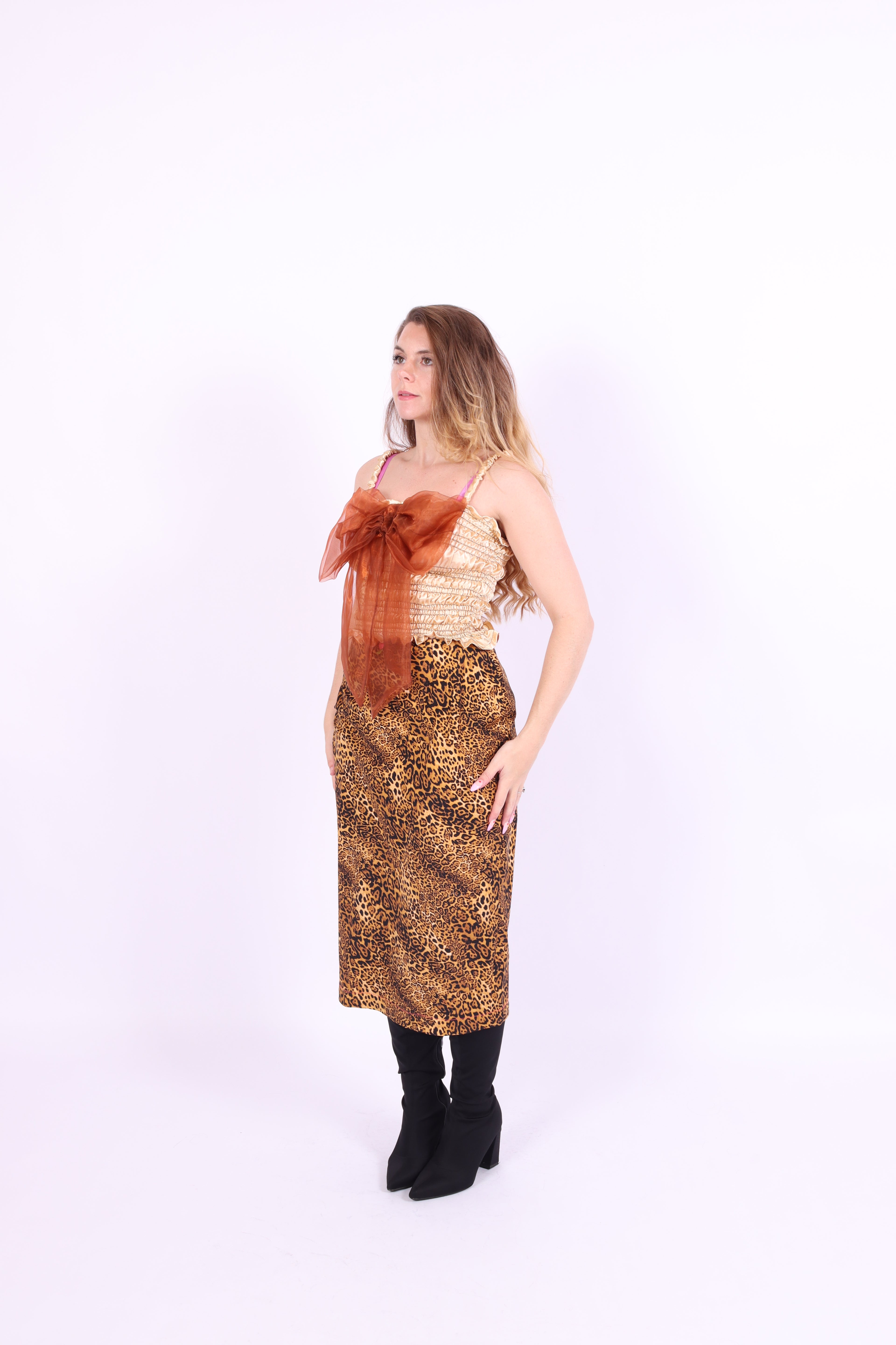 A gold satin top with an elasticated shirring bodice and a terracotta brown organza bow on the front. It features shoulder straps with elasticated and ruched details. Delta Of Phoenix Naomi Bow Top