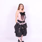 A pink bandeau top with a large black bow on the front, featuring elasticated shirring bodice and ruched shoulder straps. Delta Of Phoenix Giselle Bow Top